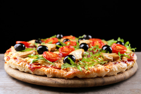 Delicious tasty pizza on black backgroundの写真素材