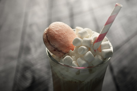 Cup of coffee with whipped cream and macaroonの写真素材