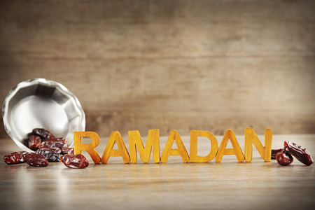 Ramadan word with wooden letters and dry dates on tableの写真素材