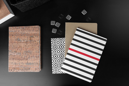 Notebooks with stickers on black tableの写真素材