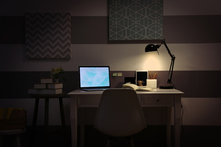 Stylish workplace with laptop at homeの写真素材