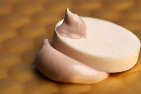Makeup sponge with liquid foundation on abstract backgroundの写真素材