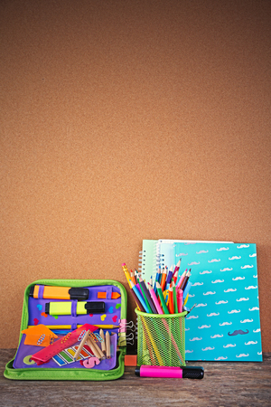 Pencil case with various stationery on old  wooden tableの写真素材