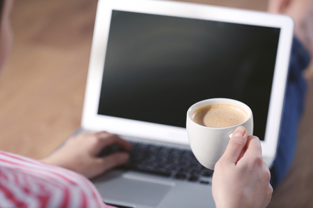 Woman sitting on the floor and working with a laptopの写真素材