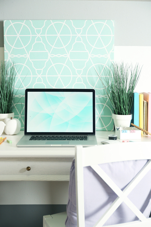 Workplace with table and laptop in living roomの写真素材
