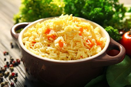Pan of vegetarian rice with allspice on wooden table closeupの写真素材