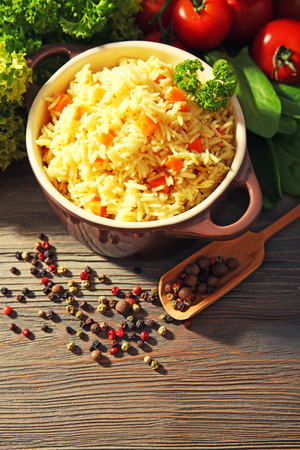 Pan of vegetarian rice with allspice on wooden table closeupの写真素材