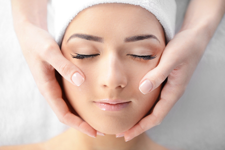 Spa concept. Face massage. Young woman getting spa treatment, close upの写真素材