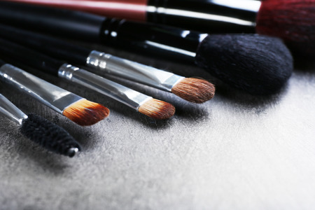 Makeup brushes on gray background