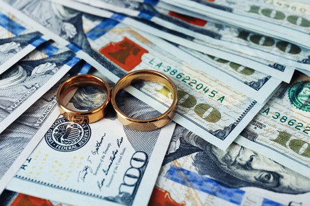 Wedding rings on money background, close upの写真素材