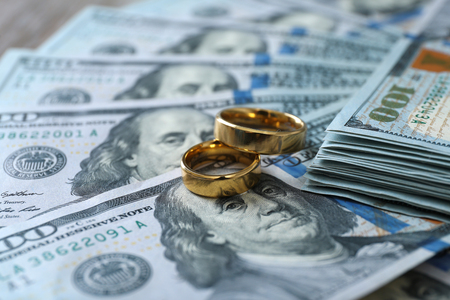 Wedding rings on money background, close upの写真素材