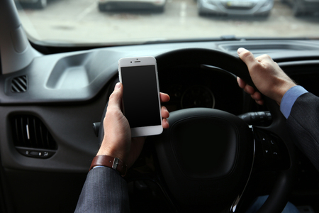 Man driver using smart phone in carの写真素材