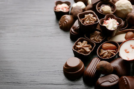Delicious chocolate candies on wooden backgroundの写真素材