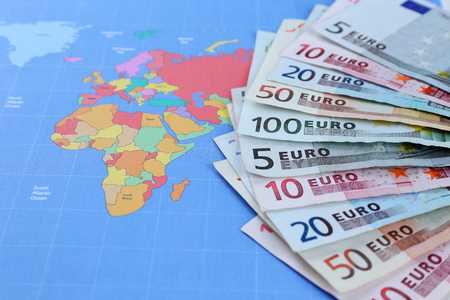 Different euro banknotes on a map backgroundの写真素材