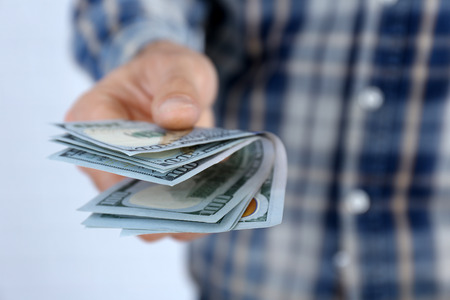 Man holding dollars in hand