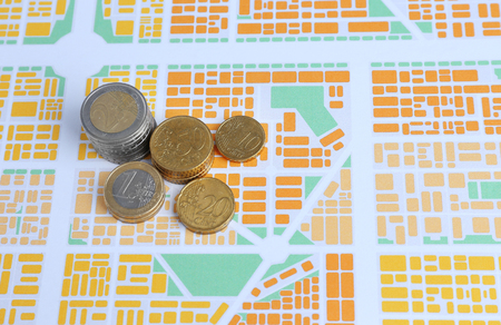 Euro coins on map background