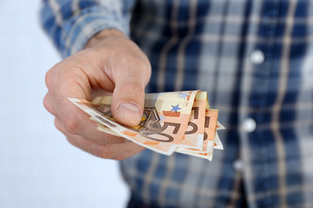 Man holding euros in handの写真素材
