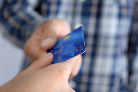 Hands holding a credit cardの写真素材