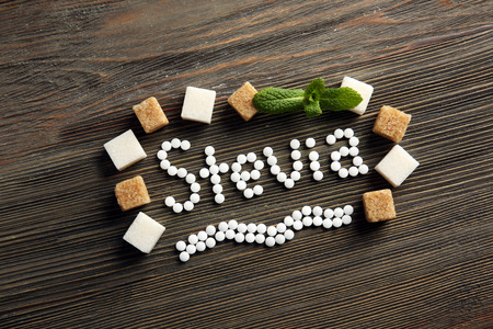 Word Stevia in sugar frame on wooden backgroundの写真素材