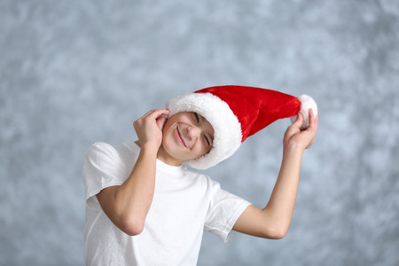 Portrait of cheerful boy on grey backgroundの写真素材