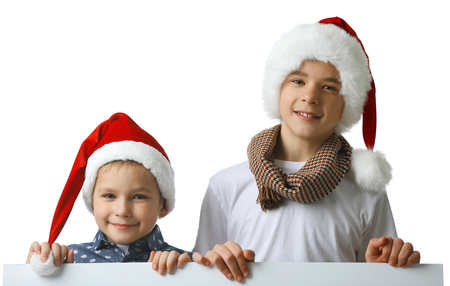 Brothers in Santa hats isolated on white background, close upの写真素材