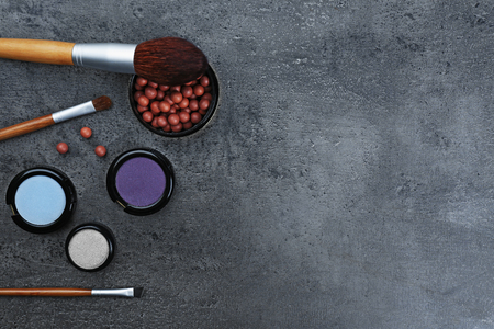 Make-up brushes, eye-shadow and blusher, on grey backgroundの写真素材