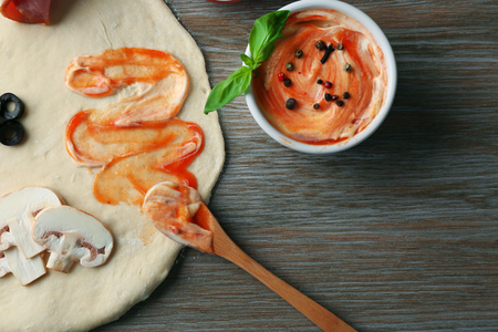 Fresh ingredients for pizza preparing on wooden tableの写真素材