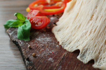 Fresh ingredients for pizza preparing on wooden table, close upの写真素材