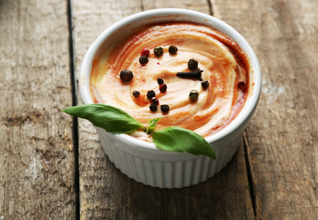 Bowl of fresh pizza sauce on wooden background, close upの写真素材