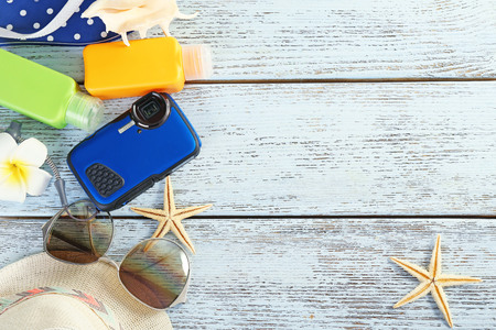 Summer accessories on wooden table, close up