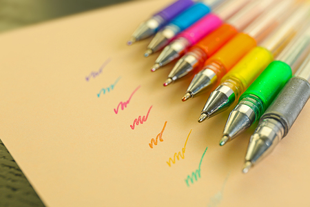 Set of colored pens on beige paperの写真素材