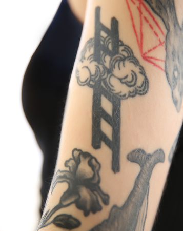Tattoo of steps in the clouds on female arm on white backgroundの写真素材