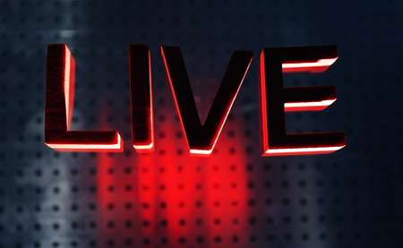 Live inscription with red letters on a lightened glassの写真素材