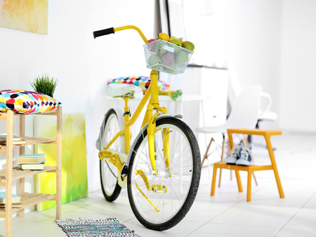 Yellow bicycle in light living room interiorの写真素材