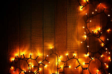 Electric Christmas garland on wooden background