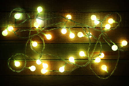 Electric Christmas garland on wooden background