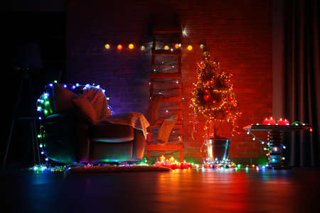 Christmas tree and other decor in dark roomの写真素材