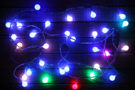 Electric Christmas garland on wooden background
