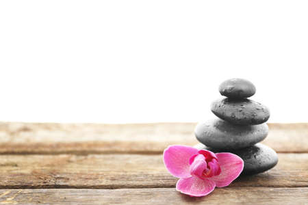 Spa stones with purple orchid on white backgroundの写真素材
