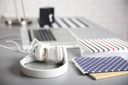 Headphones and laptop on gray table against defocused backgroundの写真素材