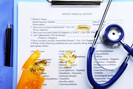 Medical stethoscope, clipboard, coat and pills, close-upの写真素材