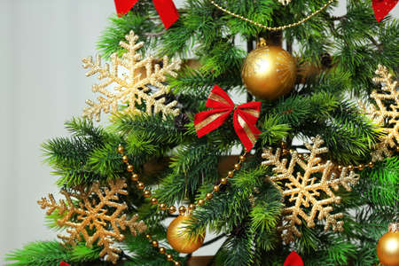 A handmade Christmas tree and presents on white wall background, close-up