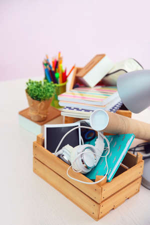 Wooden boxes with things for relocation on light table