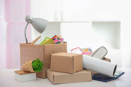 Cardboard boxes with things for relocation on light tableの写真素材