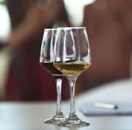 Two glasses of different wine on a table. Tasting wine conceptの写真素材
