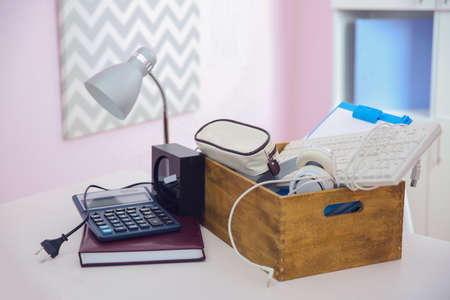 Wooden box with things for relocation on light tableの写真素材
