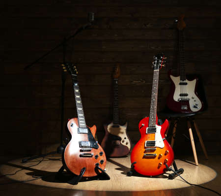 Electric guitars on lighted wooden background