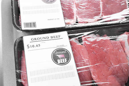 Packed pieces of pork and beef meat on metal backgroundの写真素材