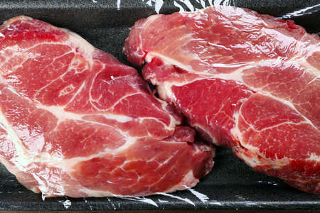 Packed pieces of pork meat, close up
