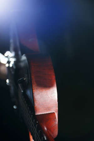 Brown electric guitar on dark backgroundの写真素材